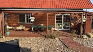 a deck with a table and chairs on a house at Ferienwohnung Dietje in Stedesdorf