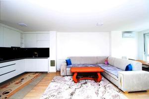 a living room with a couch and a table at Apartman Dijamant in Sarajevo