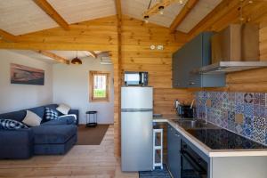 a kitchen with a refrigerator and a couch in a room at Atessa Escapes in Atessa
