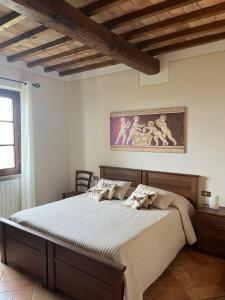 a bedroom with a bed and a painting on the wall at Agriturismo Il Fornello in Volterra