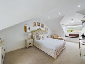 a white bedroom with a white bed and a window at Modern 4 Bed Walk to Pubs, Shops and Countryside in Stanhope