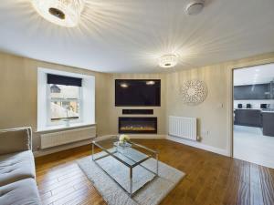 a living room with a couch and a fireplace at Charming 3 Bedroom Home in the Heart of Stanhope in Stanhope