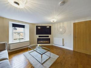 a living room with a couch and a fireplace at Charming 3 Bedroom Home in the Heart of Stanhope in Stanhope +19 photos