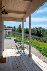a patio with a table and a chair on a porch at Atessa Escapes in Atessa