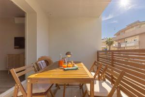 a wooden table and chairs on a balcony at Appartamenti al Mare - Il Riparo d'aMare in Alba Adriatica