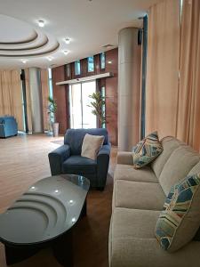 a living room with a couch and a table at Ararat Hotel in Yerevan