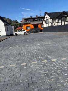 a parking lot with a car parked in front of a building at Buttermarkt House ``Rooms at the Ring`` in Adenau