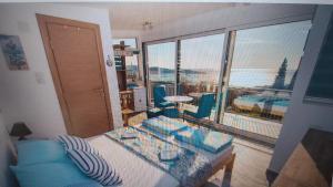 a bedroom with a bed and a balcony with a view at Viola Apartmans Lux in Šušanj