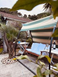 a hammock and a table and a bed in a backyard at Cavo Beach 3 in Cavo