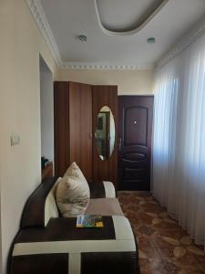 a hotel room with a bed and a mirror at Sanahin Old&New in Alaverdi +1 photo