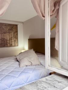 a bed with a pillow sitting next to a window at Cavo Beach 3 in Cavo