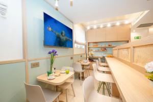 a kitchen and dining room with tables and chairs at Atlantis Lodge in Marsalforn