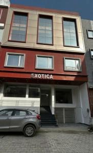 a car parked in front of a building at Hotel Exotica Haridwar in Rāiwāla