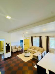 a living room with a couch and a table at We Call it Home - Bububu Villa in Mtoni
