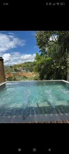 a large swimming pool with blue water in it at Igarata Cabana da Sol in Igaratá