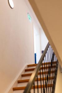 a staircase in a house with a sign on the wall at Buttermarkt House ``Rooms at the Ring`` in Adenau +39 photos