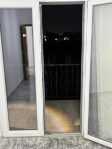an open sliding glass door with a view of a balcony at Villa serenità in Tirana