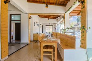 a dining room with a wooden table and chairs at Mukteshwar Valley Resort in Mukteshwar