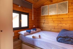a bedroom with two beds in a wooden cabin at Camping Cantabria in Polientes +20 photos