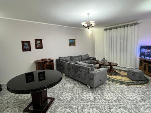 a living room with a couch and a table at Villa serenità in Tirana