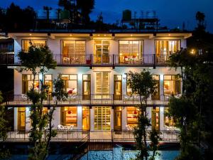 an exterior view of a building at night at Mukteshwar Valley Resort in Mukteshwar