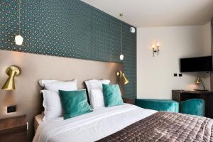 a bedroom with a bed with a green accent wall at CasaÔ in Paris