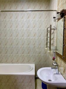 a bathroom with a sink and a bath tub at Hotel Vardonze in Bukhara +27 photos