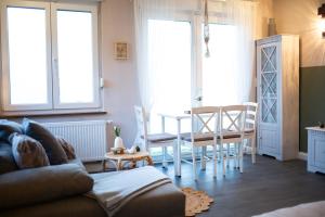 a living room with a couch and a table and chairs at Ferienwohnung Saarglück in Merzig