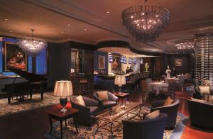 a lobby of a hotel with chairs and a bar at Shangri-La Ningbo in Ningbo