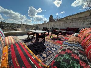 a patio with a table and a rug at Aurelia Cave Cappadocia - Special Class in Nevşehir