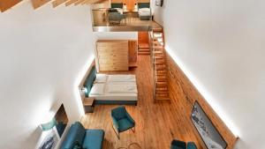an overhead view of a living room with blue chairs at Berghotel Schmittenhöhe - 2000m in Zell am See