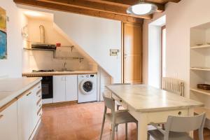 a kitchen with a table and chairs in a room at Casa Cortese Sirolo in Sirolo