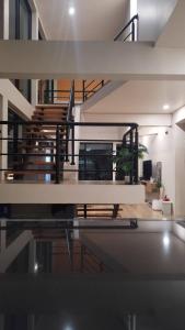 a staircase in a house with a glass floor at บ้านฮา พอชเทล Baan Ha Poshtel in Nan