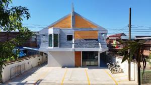 a house with a cross on top of it at บ้านฮา พอชเทล Baan Ha Poshtel in Nan