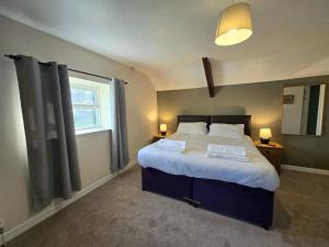 a bedroom with a large bed and a window at Newgale Lodge in Newgale +40 photos