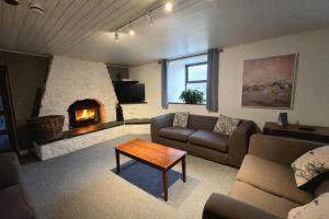 a living room with a couch and a fireplace at Newgale Lodge in Newgale