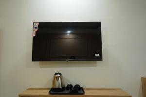a flat screen tv hanging on a wall at Hotel Starwing in Pāonta Sāhib