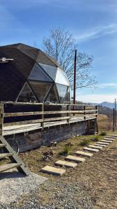 a building with a glass dome on the side of it at Dom Vladeasa in Rogojel