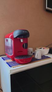 a red coffee maker sitting on top of a counter at Chez David in Bressuire +4 photos