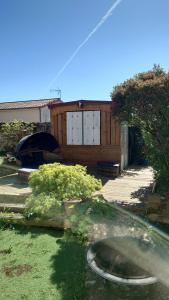 a yard with a house with a hose at Chez David in Bressuire