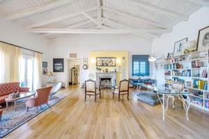 a living room with a table and chairs and a fireplace at Villa Olea Corfu - Private Pool & Panoramic Views in Perama