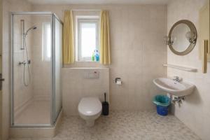a bathroom with a shower and a toilet and a sink at BLACKCOMs Erika in Goslar