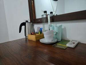 a counter with a coffee maker and a cup on it at Wilpattu Corridor Leisure in Wilpattu