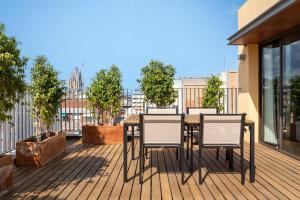 a deck with a table and chairs on a balcony at Europark in Barcelona +85 photos