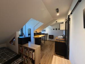 a kitchen and living room with a table and a counter at studio moderne in Barcelonnette