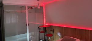 a room with red lights on the wall at Hotel Suíte in Brasília +19 photos