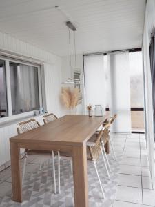 a dining room with a wooden table and chairs at Ferienwohnung Schwarzwald Lodge in Schömberg