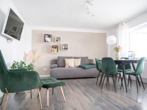 a living room with a couch and a table and chairs at Ferienwohnung Schwarzwald Lodge in Schömberg