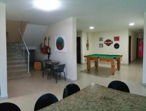 a room with a ping pong table and stairs at Pousada Casagrande - Roma in Volta Redonda