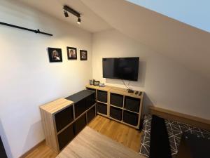 a living room with a flat screen tv on a wall at studio moderne in Barcelonnette +4 photos